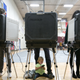 Sloane (no last name given), 2, waits between her father’s legs as he and other voters cast their ballots at a polling station set up at Grady High School for the mid-term elections on November 6, 2018 in Atlanta, Georgia. Georgia has a tight race to elect the state’s next Governor.